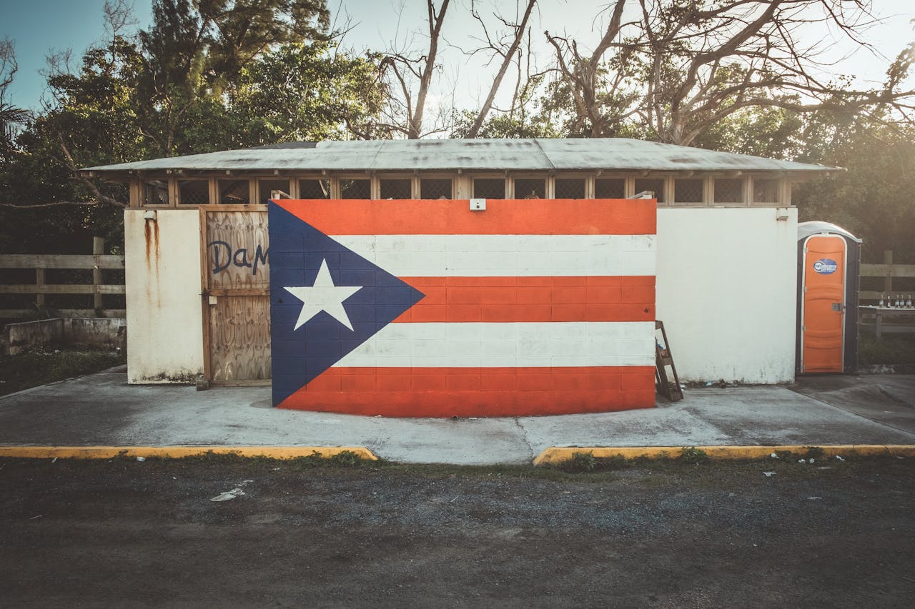 Colorful street art mural of the Puerto Rican flag in San Juan, capturing vibrant cultural expression.